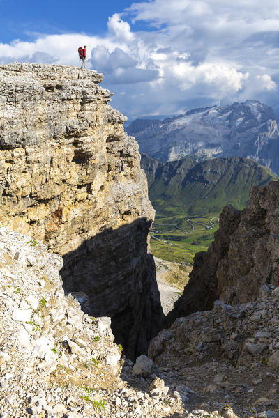 Hiker looks Marmolada. Piz Pordoi, Pass Pordoi, Fassa Valley, Trentino, Dolomites, Italy, Europe.