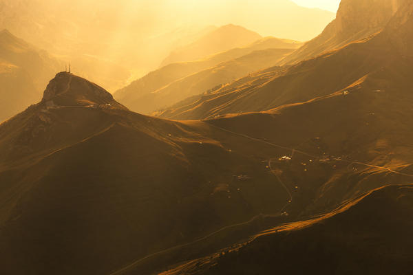 Sunlight illuminates Col Rodella at sunset. Fassa Valley, Trentino, Dolomites, Italy, Europe.