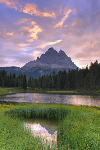 Three Peaks of Lavaredo are reflected in the Antorno Lake during sunrise. Dolomites of Sesto / Sexten, Province of Belluno, Veneto, Italy,  Europe.