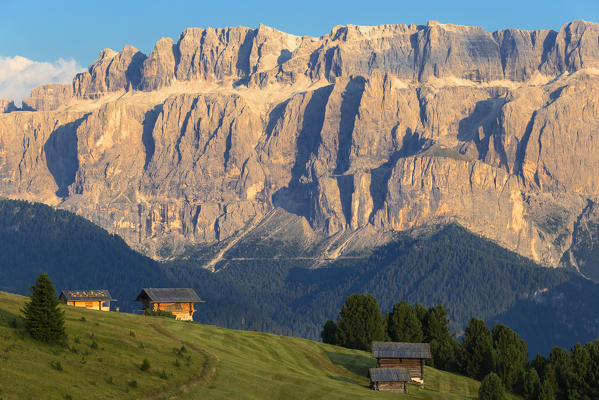 Traditional huts with Sella Group in the background. Gardena Valley, South Tyrol, Dolomites, Italy, Europe.