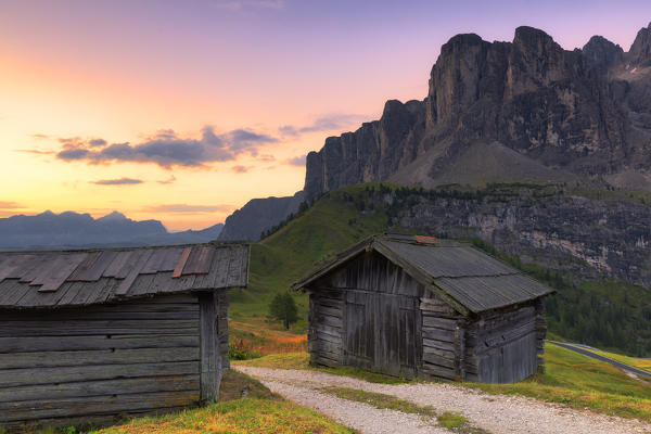 Traditional huts during sunrise at Gardena Pass, Gardena Valley, Dolomites, South Tyrol, Italy, Europe.