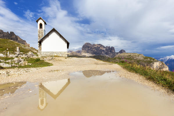 Lavaredo Chapel is reflected in a puddle. Dolomites of Sesto / Sexten, Province of Belluno, Veneto, Italy,  Europe.