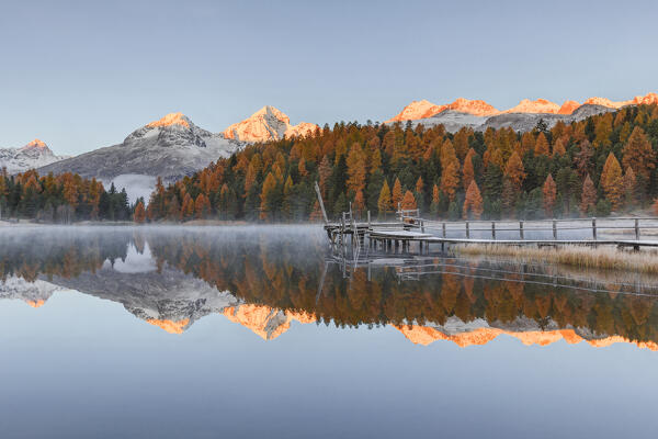 First lights on Swiss alps from Lej da Staz (Lake of Staz) in autumn time. Celerina/Schlarigna, St Moritz, canton of Graubünden, Engadine, Switzerland, Europe