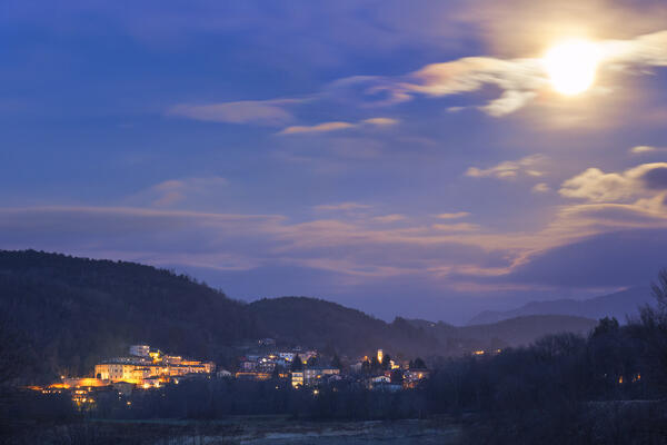 The lights of Parè village lights up in the moonlight at evening, Como province, Lombardy, Italy, Europe