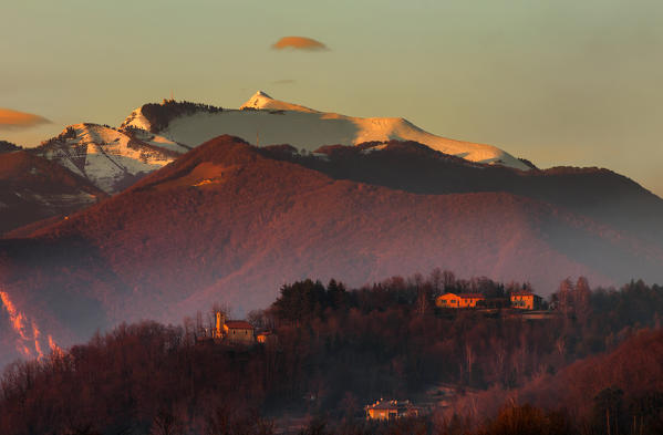 Sunset on Generoso mount, Alpe Caviano (Mendrisio district, Canton of Ticino, Switzerland), Santuario dell’Assunta (Drezzo, Como province, Lombardy, Italy), Europe