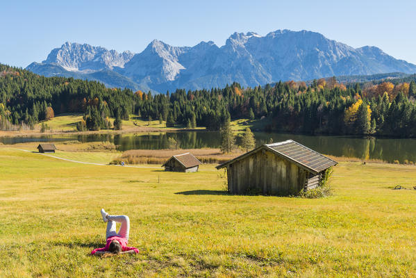 Gerold, Garmisch Partenkirchen, Bavaria, Germany, Europe. A girl relaxing on a meadow near lake Gerold