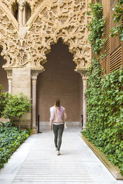 A tourist walks trough the patio of Saint Isabel. Aljaferia palace, Zaragoza, Aragon, Spain, Europe (MR)