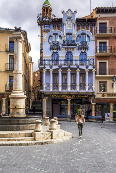 A tourist walks in Plaza del Torico, Teruel, Aragon, Spain, Europe (MR)