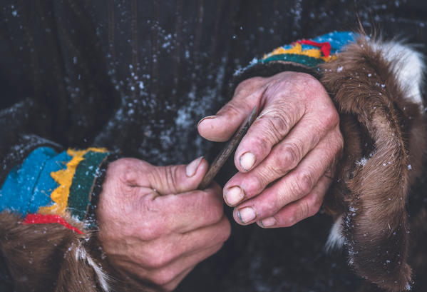 The working hands of nenets herders. The traditional way of daily life at the nomadic reindeer herders camp. Polar Urals, Yamalo-Nenets autonomous okrug, Siberia, Russia