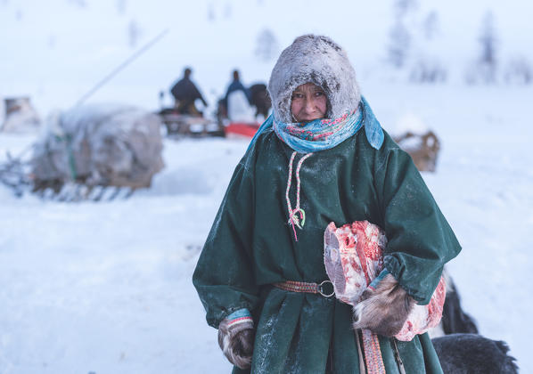 Nenets woman dressed in the traditional way at the nomadic reindeer herders camp. Polar Urals, Yamalo-Nenets autonomous okrug, Siberia, Russia