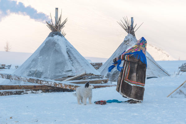 Nenets woman dressed in the traditional way at the nomadic reindeer herders camp. Polar Urals, Yamalo-Nenets autonomous okrug, Siberia, Russia