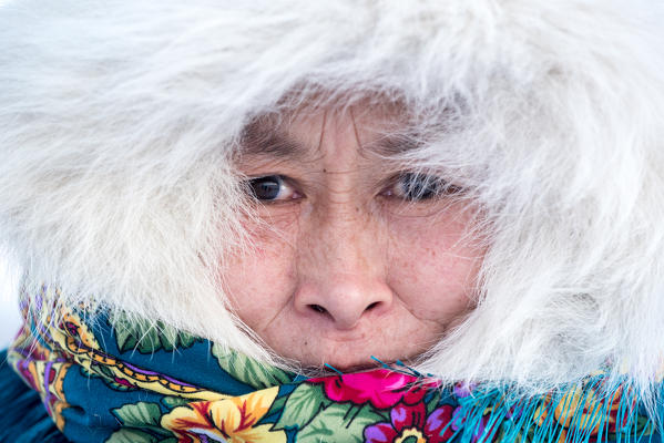 Nenets woman with the traditional fur coat at the nomadic reindeer herders camp. Polar Urals, Yamalo-Nenets autonomous okrug, Siberia, Russia