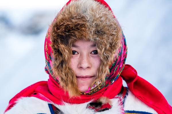 Nenets woman with the traditional fur coat at the nomadic reindeer herders camp. Polar Urals, Yamalo-Nenets autonomous okrug, Siberia, Russia