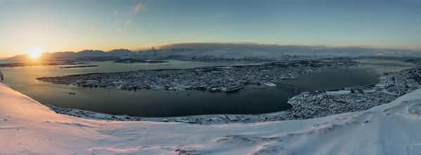 Panoramic view of the city of Tromsø at sunset from the mountain top reached by the Fjellheisen cable car, Northern Norway, Europe