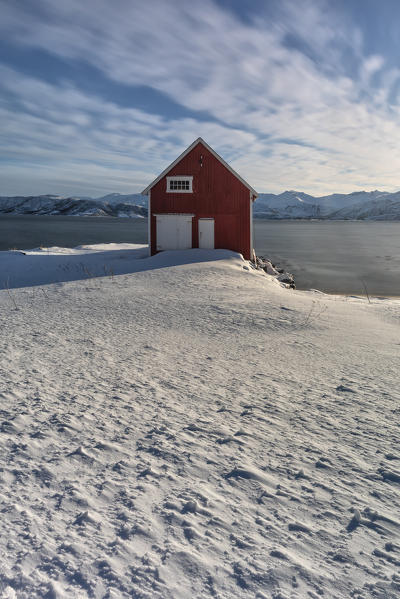 a long exposure to take a photo of rorbuer in Skaland, on a cold winter morning, Bergsfjorden, Senja, Northern Norway, Europe.
