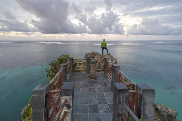 a tourist enjoy the sunrise at Captain Matthew Flinders monument, admiring the Ocean, Black River distric, Mauritius, Indian Ocean, Africa