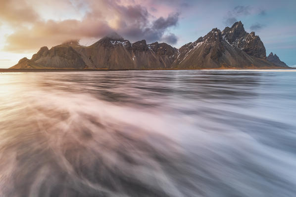photograph the Vestrahorn mountain with your feet in the water, Stokksnes, Hofn, Eastern Iceland, Iceland, Europe.