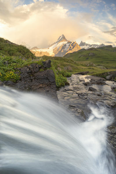 a small waterfall shot near the Bachalpsee, with the peak of the Schreckhorn in the background, Grindelwald, Canton of Bern, Switzerland, Europe