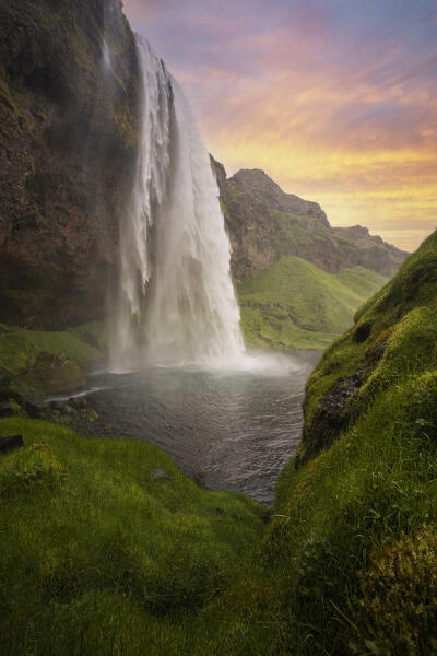 an amazing colorful sunset at Seljalandsfoss waterfall, Sudurland, Iceland