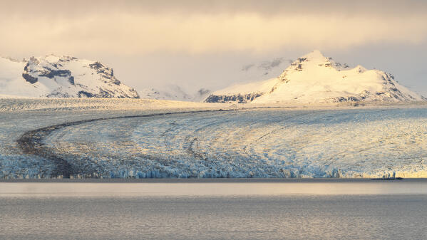 a warm light envelope th Jokusarlon Glacier Lagoon, during a warm winter sunset, Austurland, Iceland, Europe