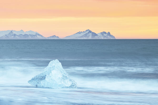 a block of ice at Diamond Beach taken during a winter sunset, Jokusarlon Glacier Lagoon, Austurland, Iceland, Europe