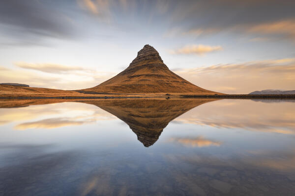 a long exposure to capture the Kirkjufell mount reflected in a little lagoon during a winter sunrise, Snaefells Peninsula, Vesturland, Iceland, Europe