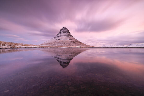 a long exposure to capture the Kirkjufell mount reflected in a little lagoon during a winter sunrise, Snaefells Peninsula, Vesturland, Iceland, Europe
