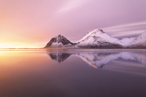 The Vestrahorn reflected in the bay during a winter sunrise, Austurland, Southern Iceland, Europe