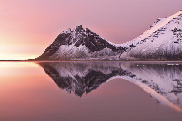 The Vestrahorn reflected in the bay during a winter sunrise, Austurland, Southern Iceland, Europe
