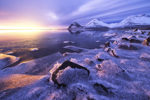 The Vestrahorn reflected in the bay during a winter sunrise, Austurland, Southern Iceland, Europe