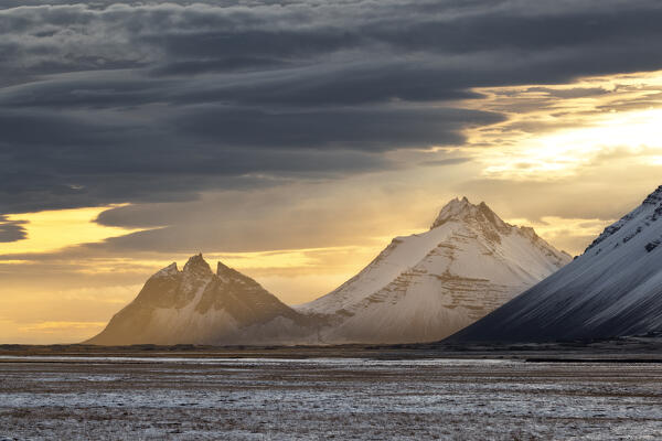 The Vestrahorn mountain illuminated by a war sun ray during a winter sunset, Austurland, Southern Iceland, Europe