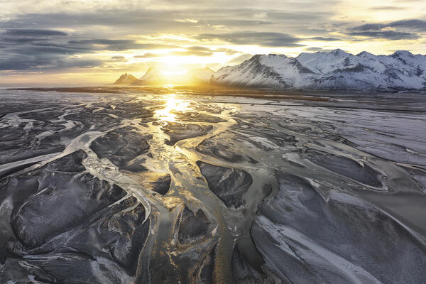 Aerial view taken by drone of Vestrahorn mountain, during a warm winter sunset, Austurland, Southern Iceland, Europe