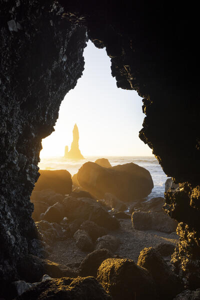 the stacks of Vik i Myrdal, seen from an hidden cave during a winter sunrise, Reynisfjara beach, southern Iceland, Europe