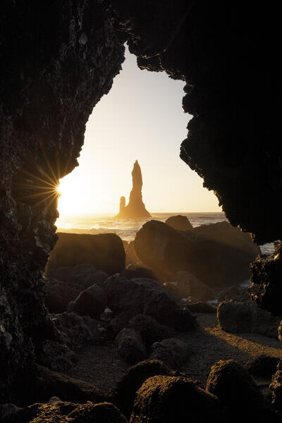 the stacks of Vik i Myrdal, seen from an hidden cave during a winter sunrise, Reynisfjara beach, southern Iceland, Europe