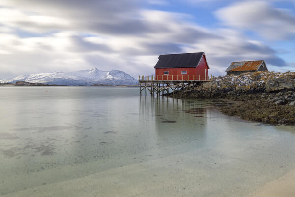 a classic rorbuer along the coast of hillesoya island during a cloudy winter day, Hillesoya, Troms, Norway, Europe