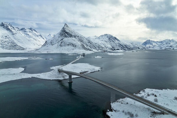 aerial view taken by drone of the bridge to connect Fredvang at Ramberg, during a winter sunrise, Lofoten island, Norway, Europe