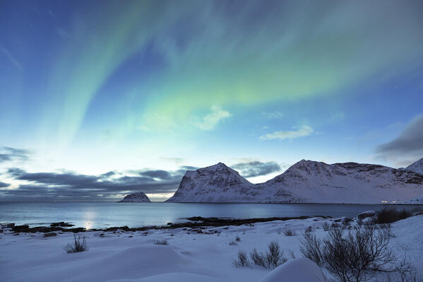 the magic of the arctic skies with the Northern Lights at Haukland beach, Lofoten island, Norway, Europe