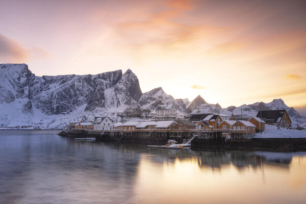 Winter sunset over Sakrisoy village with mountain peak covered with snow, Lofoten Islands, Norway, Europe