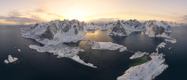 Winter sunset over Reine Bay, Sakrisoy and Hamnoy village with Olstind peak covered with snow, Lofoten Islands, Norway