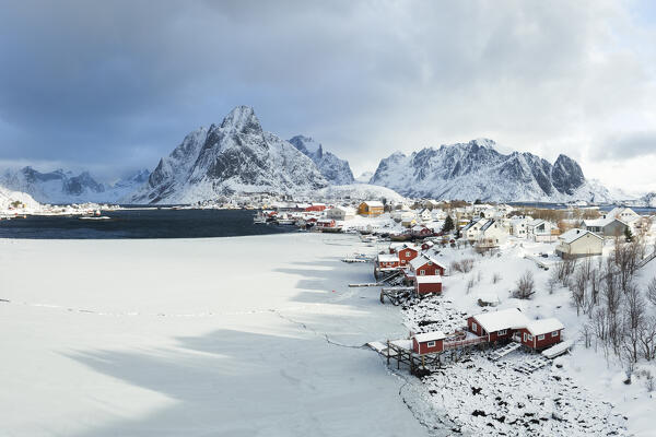 Winter day in Reine village with mountain peak covered with snow, Lofoten Islands, Norway, Europe