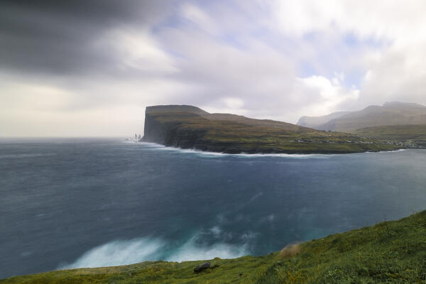 one sea storm hits the Risin og Kellingin cliffs during an autumn day, Eysturoy, Faroe Islands, Denmark, Scandinavia