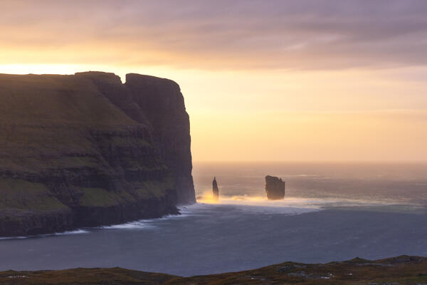 a magical light envelope the Risin og Kellingin during an autumn sunset, Sunda municipality, Eysturoy, Faroe Islands, Denmark, Scandinavia