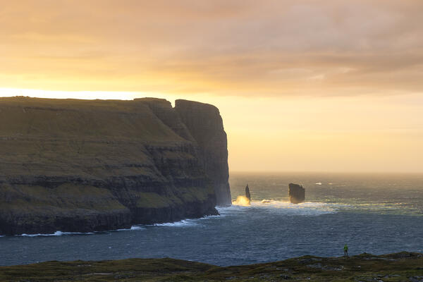 one person enjoy the sunset at Risin og Kellingin, Sunda municipality, Eysturoy, Faroe Islands, Denmark, Scandinavia