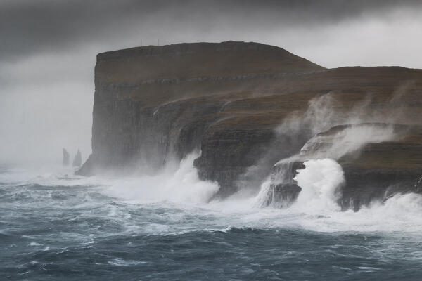 one sea storm hits the Risin og Kellingin cliffs during an autumn day, Eysturoy, Faroe Islands, Denmark, Scandinavia