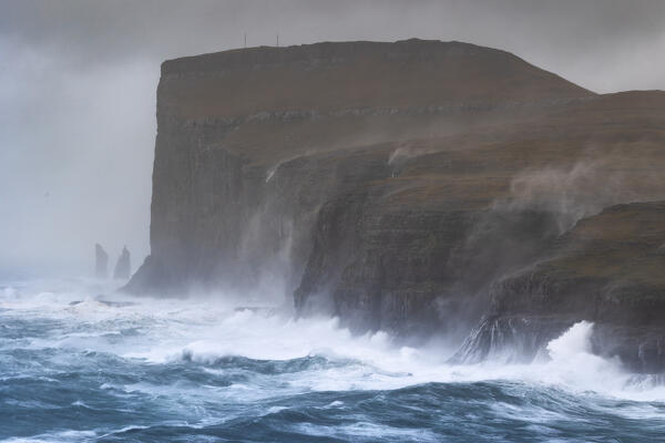 one sea storm hits the Risin og Kellingin cliffs during an autumn day, Eysturoy, Faroe Islands, Denmark, Scandinavia