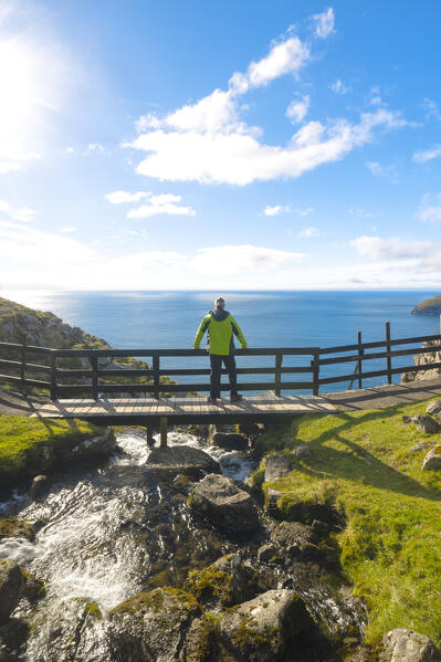 one person enjoy the beautiful view from Trollkonufingur or Witches Finger, Sandavagur, Vagar, Faroe Islands, Denmark, Scandinavia, Europe