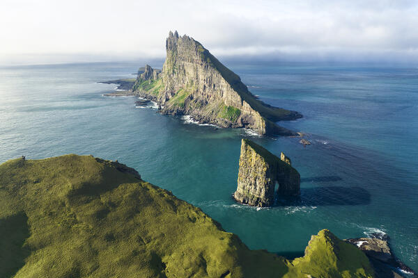 aerial view taken by drone of  Tindholmur and Draganir islands during an autumn day, Sorvagur, Faroe Island, Europe