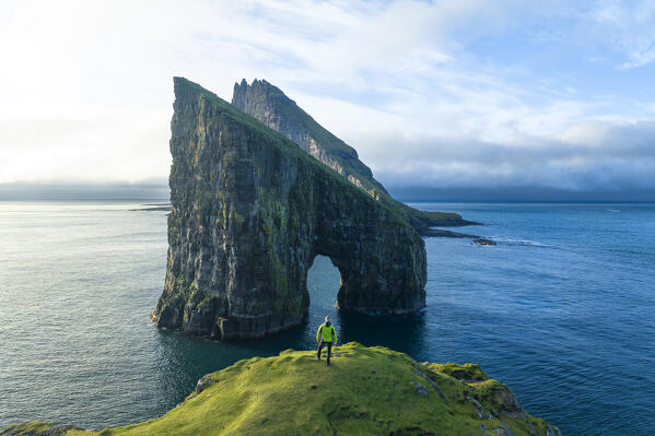 aerial view taken by drone of  Tindholmur and Draganir islands during an autumn day with one person enjoy the view, Sorvagur, Faroe Island, Europe