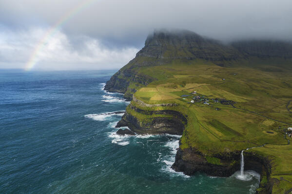 Mulafossur waterfall and the little village of Gasadalur, Vagar island, Faroe Islands, Denmark, Europe