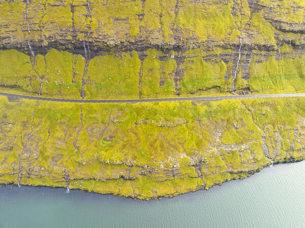 aerial view taken by drone of the road along the Funningsfjordur, Eysturoy, Faroe Island, Denmark, Europe